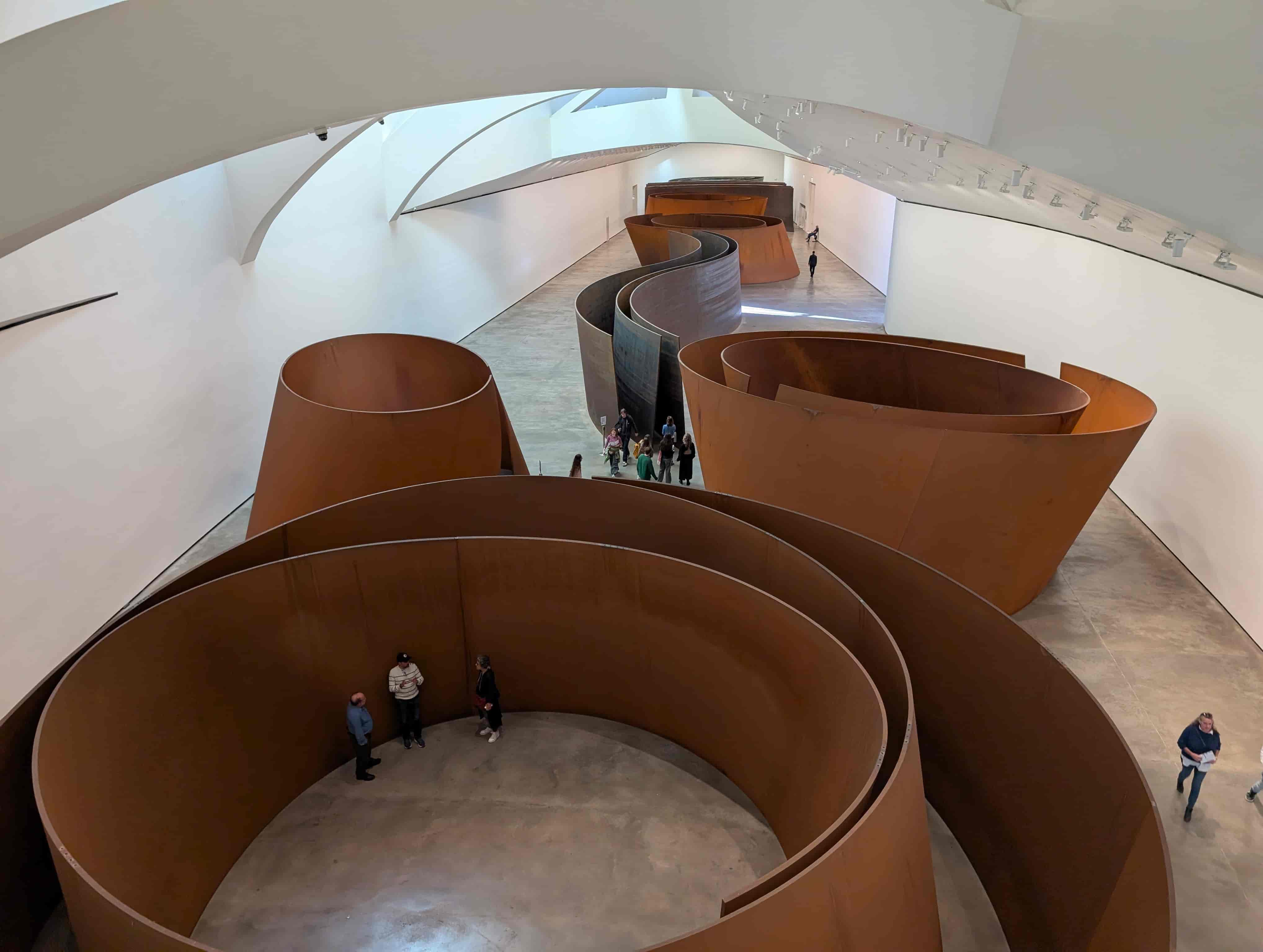 Overhead view of Richard Serra's "The Matter of Time", a series of curved steel sculptures that viewers are meant to walk through.